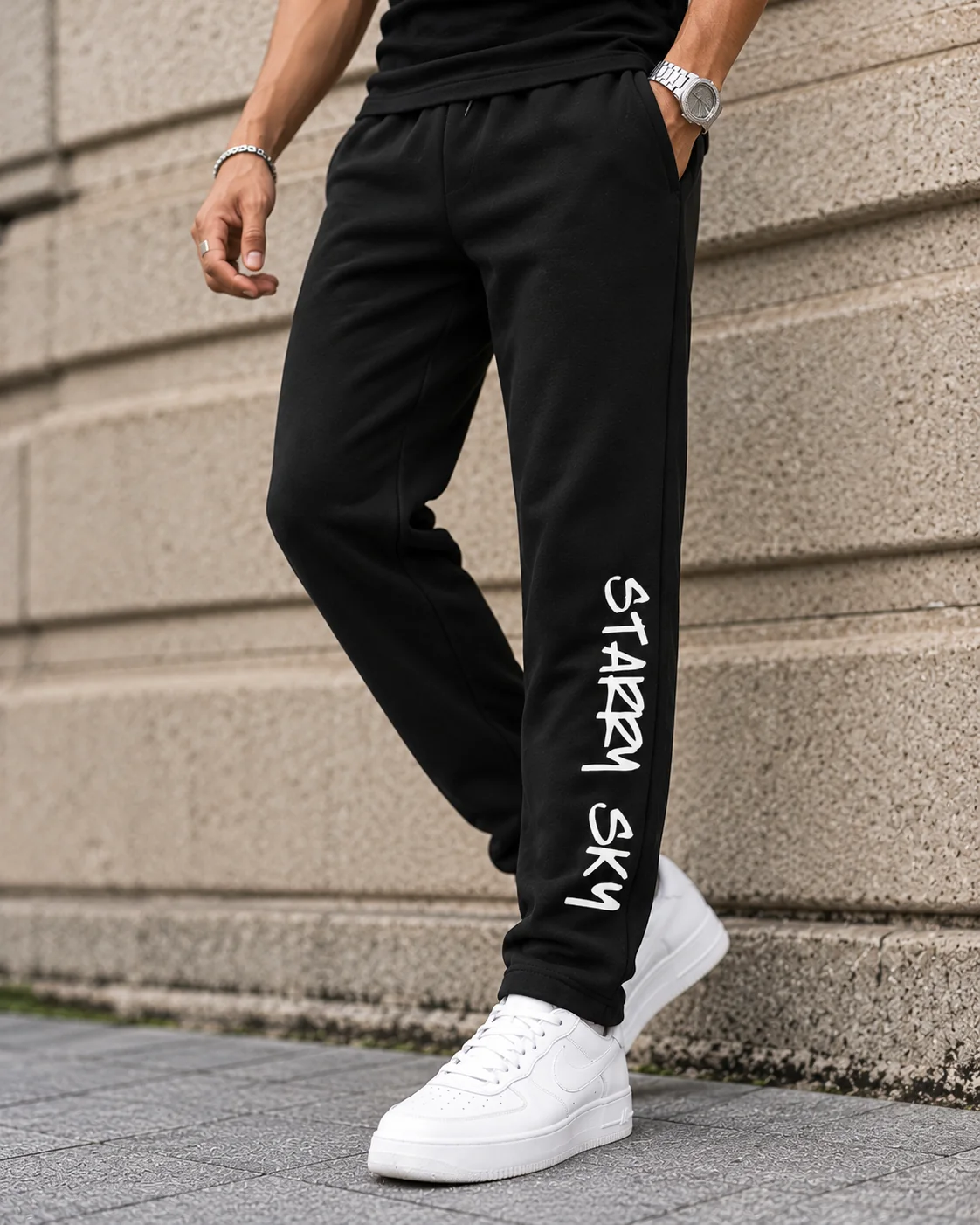 Starry Sky black graphic lowers in a cross-legged model pose